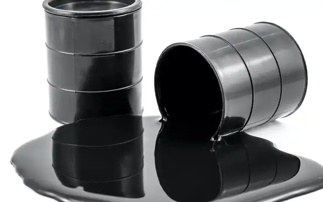 a heavy petroleum product, spilling from a drum